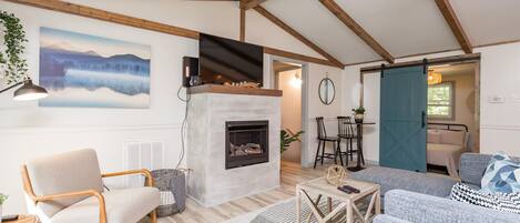 Enjoy the spacious living room with vaulted ceilings with beams, gas fireplace and cozy furniture