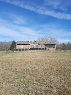 View of back side of house from the 25 acre field directly behind the house.