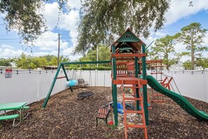 Awesome Playground with numerous swings, slide, bridge and rock climb wall for kids.