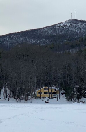 House from lake in snow