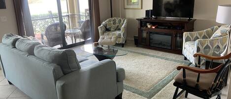 Living room with view through the lanai to the pond