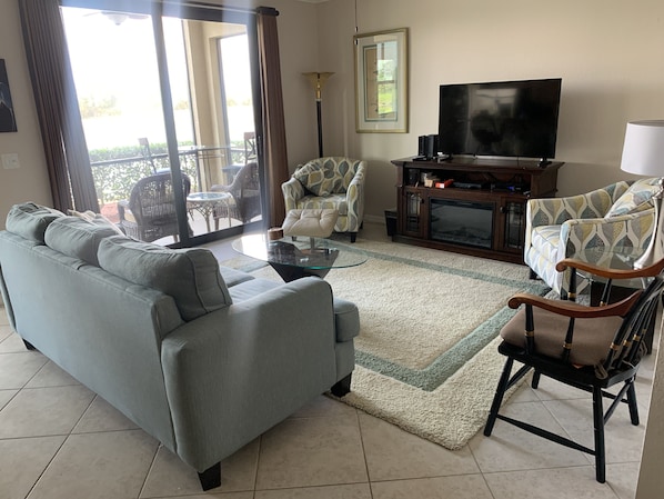 Living room with view through the lanai to the pond