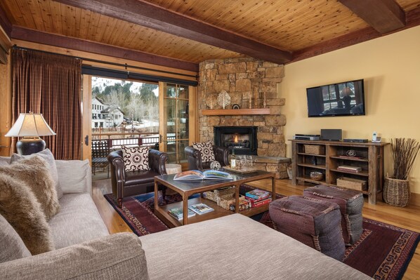 Living room with balcony and fireplace.