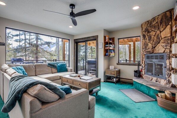Bright and cozy living area with mountain views, fireplace, and 75" smart TV
