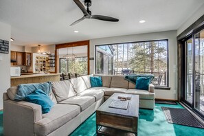 Main level of home is open and airy space between living, kitchen, and dining