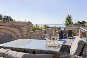 Relax on the split level patios and enjoy far reaching views across Lyme Bay