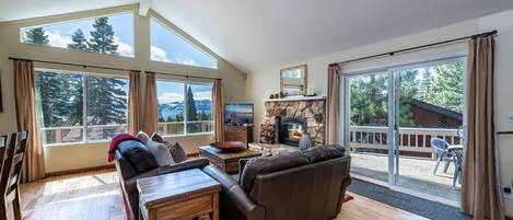 Living room with gas fireplace and lake views.