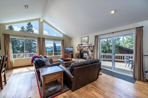 Living room with gas fireplace and lake views.