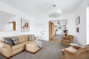 Welcome to our well-decorated living room, where a comfortable couch and plush carpeted space create the perfect ambiance for relaxation and entertainment. It's a stylish retreat that's as inviting as it is captivating.