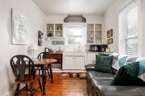 Compact convenience at its finest – our small kitchen area with microwave, coffee maker, mini fridge, and sink for your quick bites and drinks.