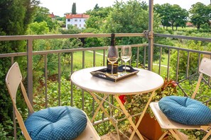Balcony. Table with chairs and the view from bedroom balcony