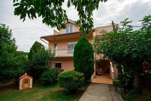 External view of the building. Front view of the house. Apartment is located on the first floor.