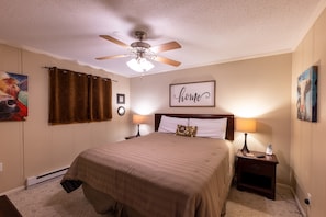 Master bedroom features a king bed with attached bathroom