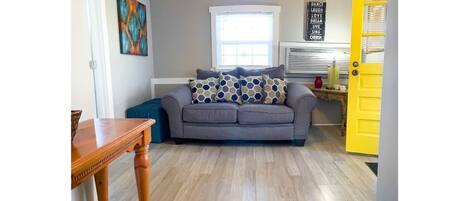 Beautifully decorated den with hardwood floors.