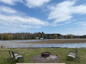 Expansive yard and fire pit near the water's edge.