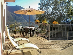 Furniture, Building, Property, Table, Umbrella, Sky, Outdoor Table, Shade, Outdoor Furniture, Chair
