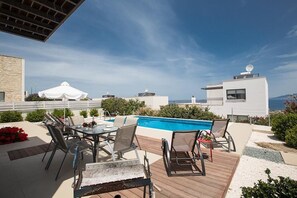Garden with barbecue, seating area, sun loungers and private pool