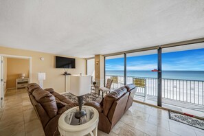 Upon entering, you'll immediately notice the beautiful travertine flooring throughout. The large living area overlooks the Gulf of Mexico with ample, comfortable reclining seating.