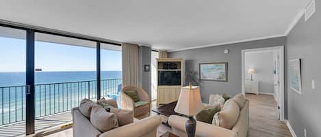 Living area with flat screen television overlooking the Gulf of Mexico.