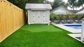 New salt water pool with heater/chiller, putting green, firepit, & grill