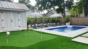 New salt water pool with heater/chiller, putting green, firepit, & grill