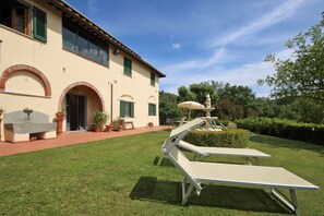 The exterior of the farmhouse and the shared garden