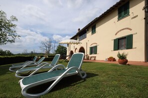 The exterior of the farmhouse and the shared garden
