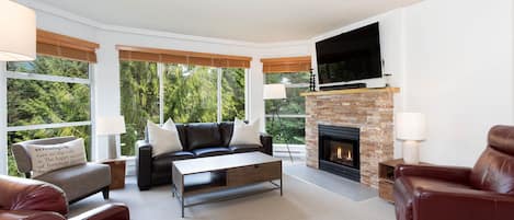 Spacious living area with large bay windows and gas fireplace