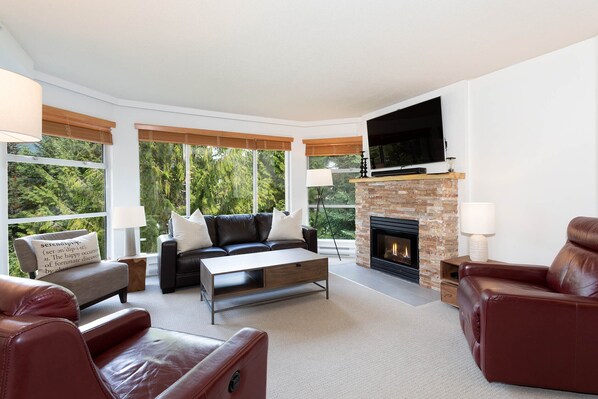 Spacious living area with large bay windows and gas fireplace