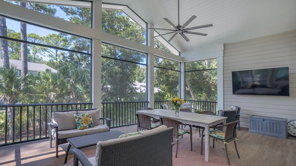 Airy screened-in porch with comfy seating