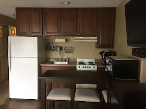 Fully stocked kitchen with new stove, refrigerator and many new utensils.