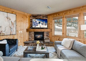 Cozy Living Room with Modern Furnishings, 60" Smart TV with Cable, and a Gas Fireplace