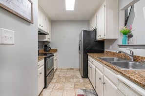 Fully stocked galley kitchen.