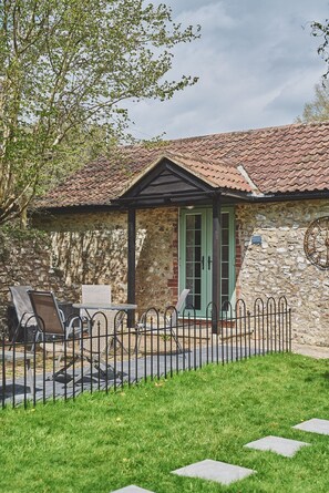 The exterior and door way of Harcombe Cottage, Devon