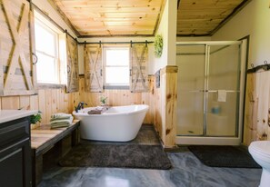 Master bathroom has a soaker tub and a shower.