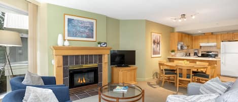 Open-plan living area featuring a gas fireplace, TV, and comfy seating