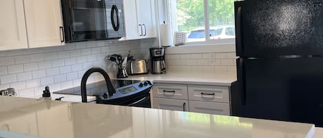 Kitchen with breakfast bar seating for four