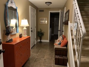 Foyer/mud room with access to garage and laundry room, patio and outdoor shower