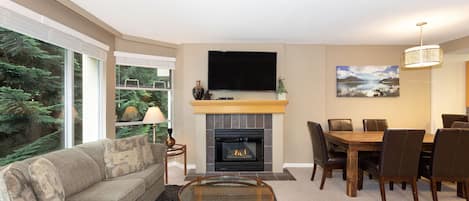 Open plan living area with TV and gas fireplace