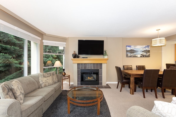 Open plan living area with TV and gas fireplace