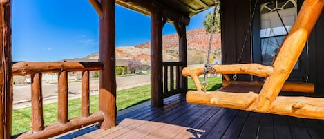 Indulge in breathtaking views from the cozy front porch swing. 