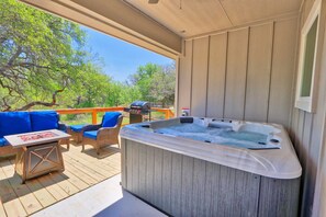 Covered hot tub next to the entertaining area