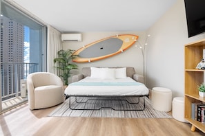 Pull-out sleeper sofa in the living room. The surfboard is for decoration only.