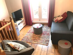 The living room, plus high table and stools (sofa converts to sofa bed).