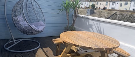 Sunny terrace with comfy swing chair great to sit and read in