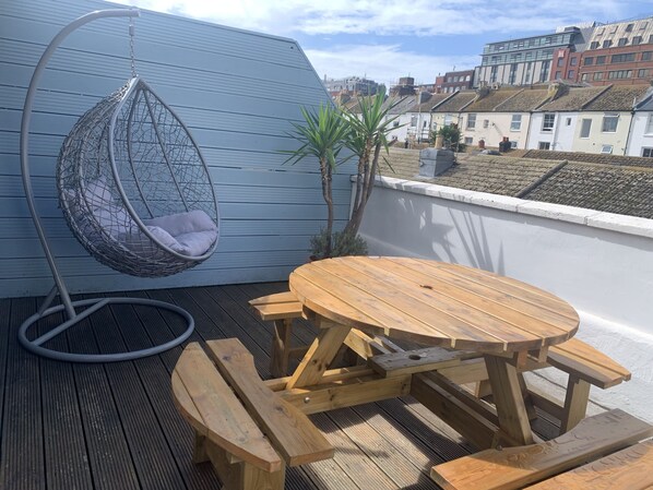 Sunny terrace with comfy swing chair great to sit and read in