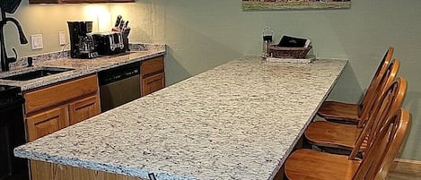 Kitchen with granite countertops, microwave, dishwasher, stove & fridge