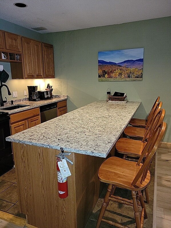Kitchen with granite countertops, microwave, dishwasher, stove & fridge