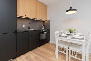 The sleek design of the kitchenette blending seamlessly with the living area.