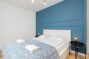 The cosy bedroom features a luxurious double bed and ample storage.